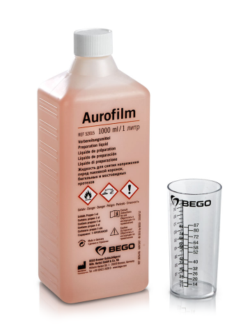bottle of aurofilm liquid and measuring cup